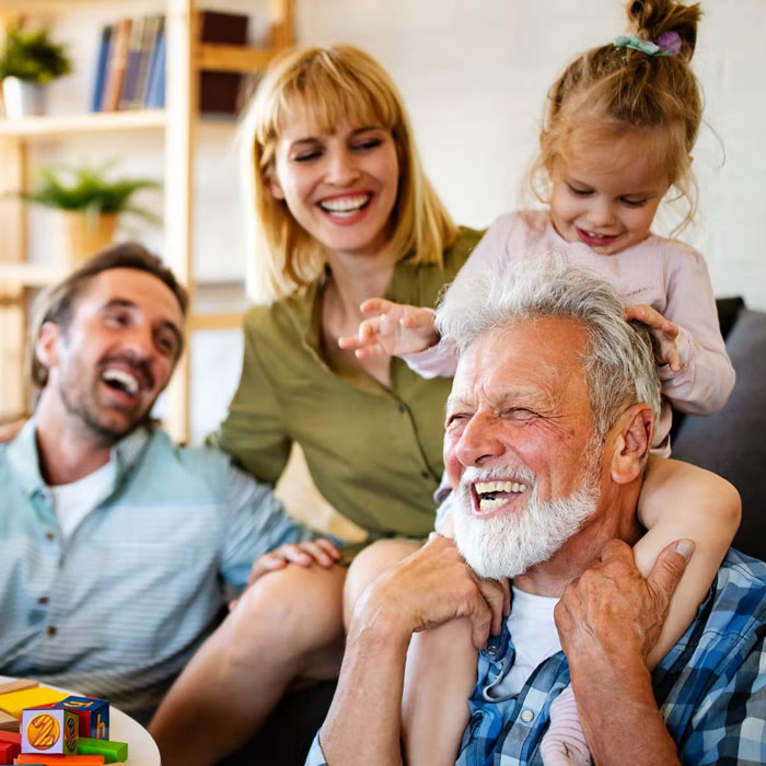 senior man enjoying time with family and granddaughter